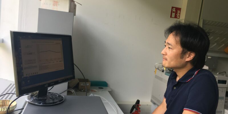 Komi checking data in the lab.